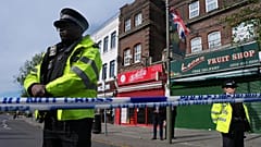 Police officers stand in the area where two people were stabbed in Golders Green, 29 April, 2026