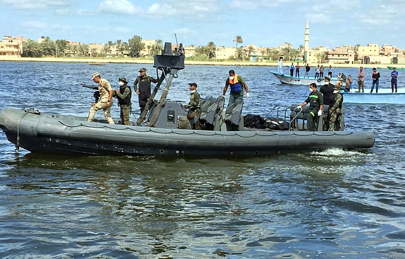 FILE: Egyptian coast guard and rescue workers bring ashore bodies from a Europe-bound boat that capsized off Egypt's Mediterranean coast, in Rosetta, 27 September 2016
