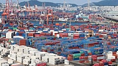 Shipping containers at a port in South Korea, highlighting trade flows between Asia and global markets.