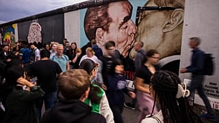 Tourists in front of the East Side Gallery in Berlin