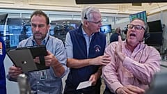 Options traders, Scott Frinzi, Dave Rushand and Marty Handler work on the floor of the New York Stock Exchange, 1 May 2026