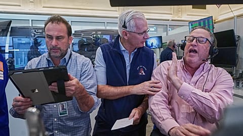 Options traders, Scott Frinzi, Dave Rushand and Marty Handler work on the floor of the New York Stock Exchange, 1 May 2026