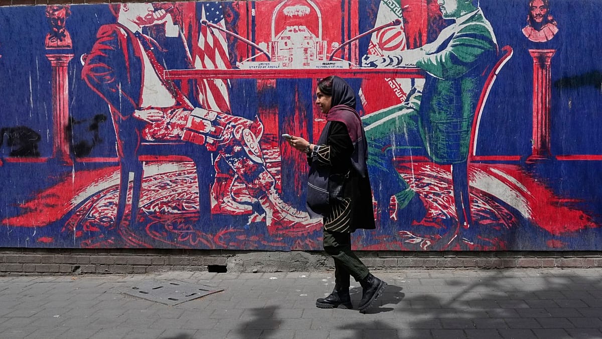 Iranians at home divided between hope for regime change and war fears