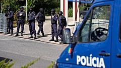 Police officers stand at the entrance of an Ismaili Muslim centre in Lisbon, 28 March, 2023