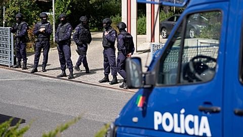 Police officers stand at the entrance of an Ismaili Muslim centre in Lisbon, 28 March, 2023