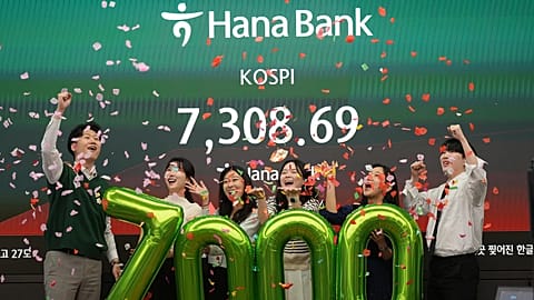 Employees of Hana Bank celebrate in a photo opportunity to mark the Korea Composite Stock Price Index (KOSPI) of over 7,000 points at Hana Bank in Seoul. 6 May 2026