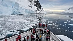 Passengers watch as a ship sails through the Lemaire Channel in Antarctica, Monday, Nov. 24, 2025.