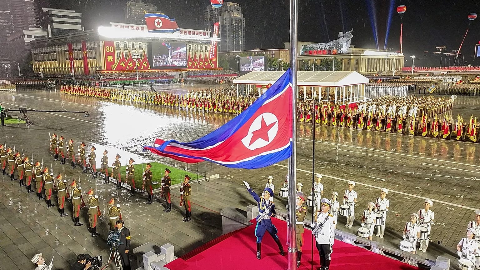 A North Korean flag is raised during the military parade marking the 80th anniversary of the founding of the ruling Worker's Party in Pyongyang, 10 October, 2025