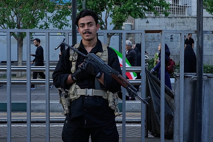 FILE: A security personnel stands guard in a state-organised rally celebrating the birthday of Imam Reza and supporting Ayatollah Mojtaba Khamenei, in Tehran, 29 April 2026