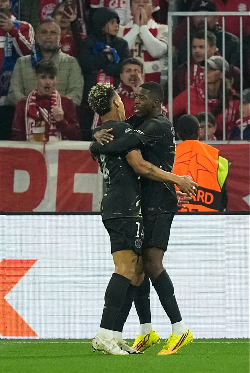 PSG's Ousmane Dembele, right, celebrates with PSG's Desire Doue after scoring his sides first goal during the Champions League semifinal