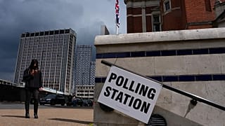 A pedestrian walks past a polling station sign during the UK local elections in London, 7 May, 2026