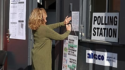 A worker prepares signs at a polling station in Walton on the Naze, 7 May, 2026