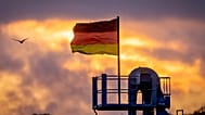 A German flag waves on top of the silo of a farm in Wehrheim near Frankfurt, 1 October, 2024