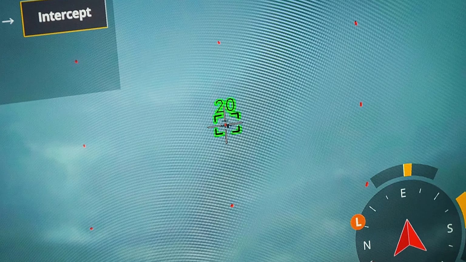 A drone pilot showing drone and target drone on monitor