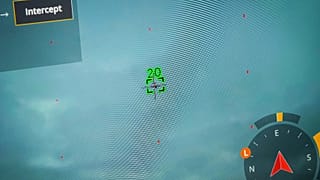 A drone pilot showing drone and target drone on monitor