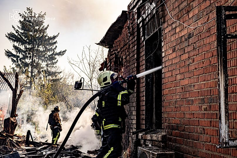 Emergency services personnel work to extinguish a fire following a Russian drone attack in Kharkiv region, 6 May, 2026
