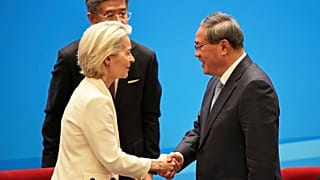 Chinese Premier Li Qiang, right, shakes hands with European Commission President Ursula von der Leyen at the end of the China Business Leaders Symposium.