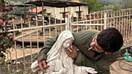 An IDF soldier places a cigarette in the mouth of a statue of the Virgin Mary in Lebanon