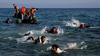 Migrants whose boat stalled while crossing from Turkey to Greece swim to the island of Lesbos, 20 September, 2015