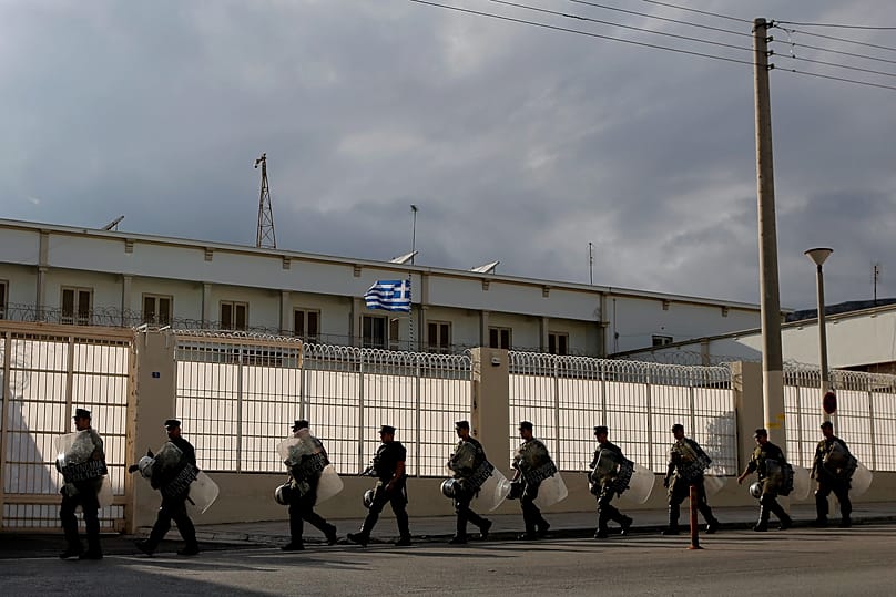 Riot police officers secure the outside of Korydallos maximum-security prison, in Athens, on Thursday, Oct. 3, 2013.