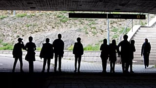 Migrant pupils walk under a railway bridge in Flen, 30 August, 2018