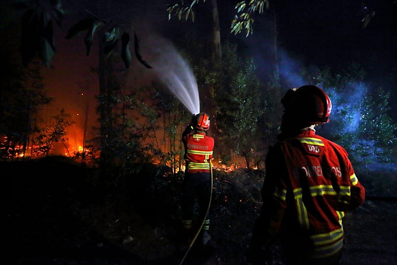 A firefighter works to extinguish a fire on the outskirts of Sever do Vouga, 18 September, 2024