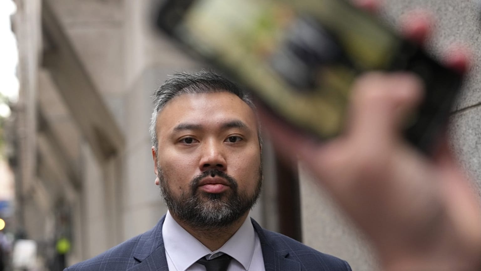 FILE - Peter Wai leaves The Old Bailey after being charged under the NSA with assisting Hong Kong's intelligence service and foreign interference, May 24, 2024