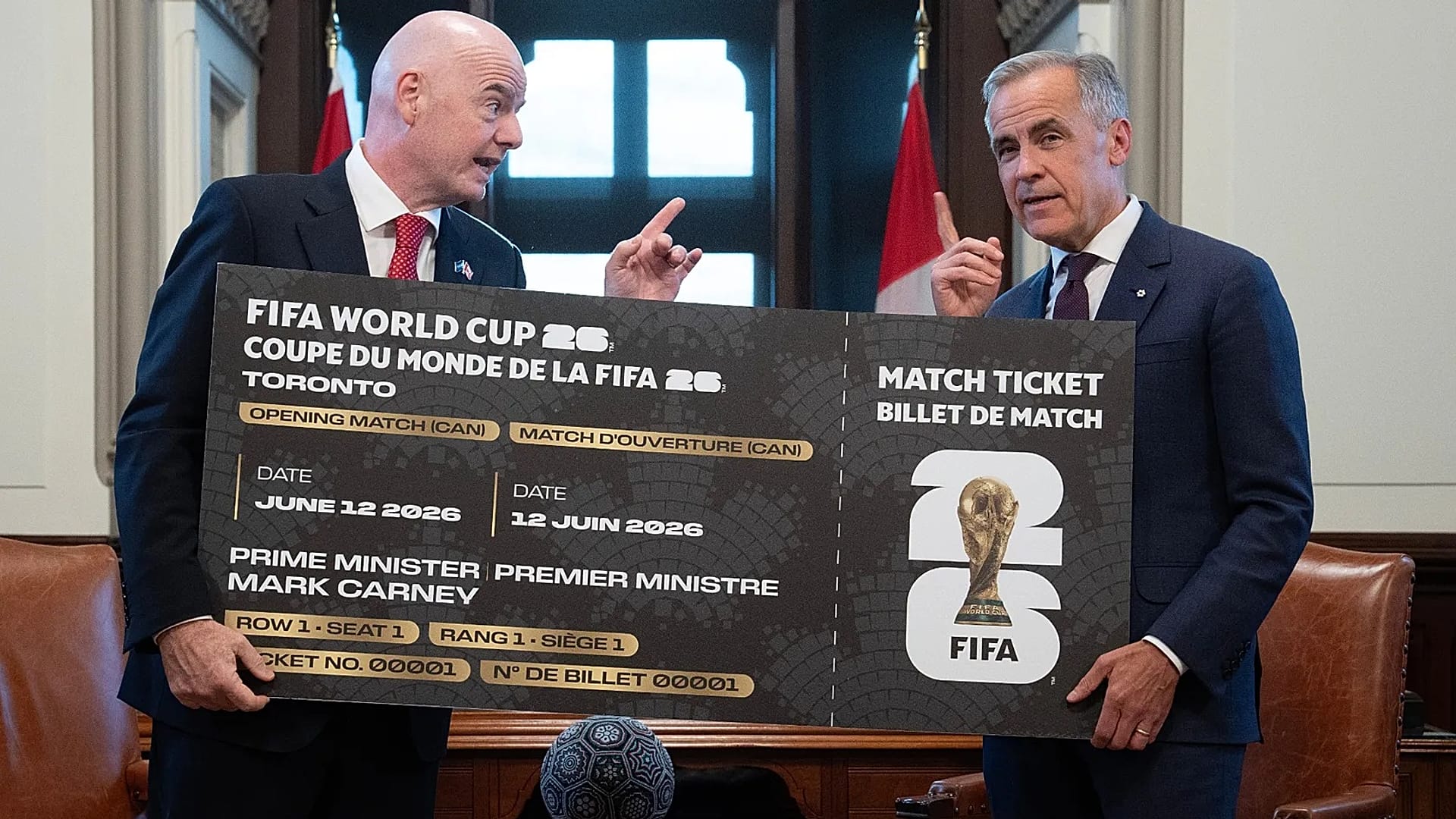 Canada Prime Minister Mark Carney, right, is presented with a novelty World Cup ticket by FIFA President Gianni Infantino on Parliament Hill in Ottawa,Friday, 10 Oct 2025.
