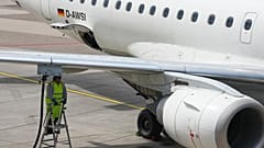 A worker fills up an aircraft with jet fuel at the airport in Duesseldorf, Germany, when airlines fear a kerosene shortage due to the war in Iran, Monday, April 27, 2026.