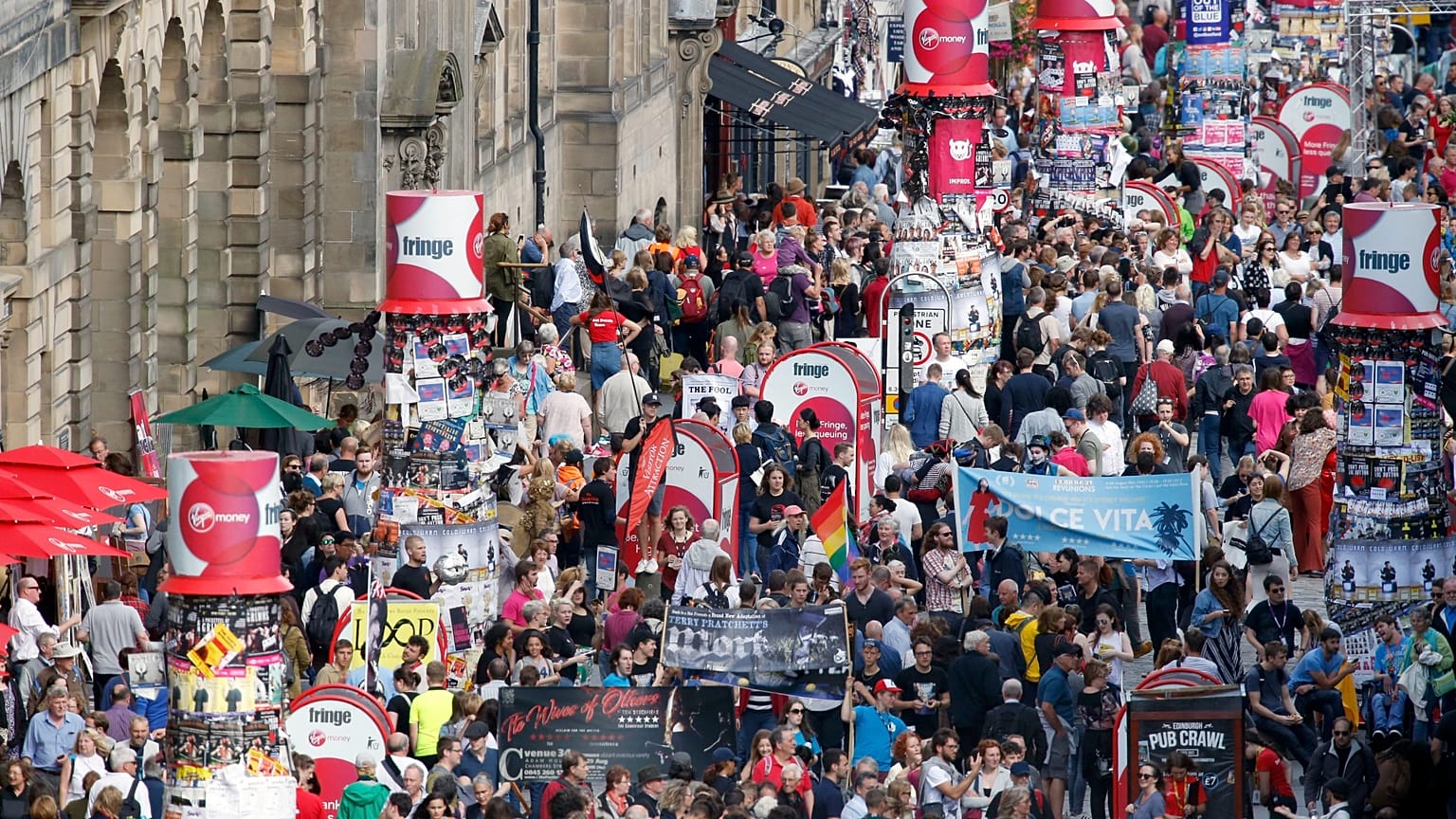 Crowds mingle on Edinburgh's Royal Mile during the 2016 Edinburgh Fringe Festival, Monday, Aug. 22, 2016. The Fringe remains the largest performing arts festival in the world 