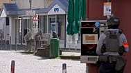 Αστυνομικός στέκεται στον τόπο του συμβάντος όπου σημειώθηκε ομηρία σε υποκατάστημα τράπεζας στο Σίνζιγκ, 8 Μαΐου 2026.