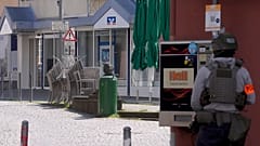 A police officer stands at the scene of an incident where a hostage situation has occurred at a bank branch in Sinzig, 8 May, 2026