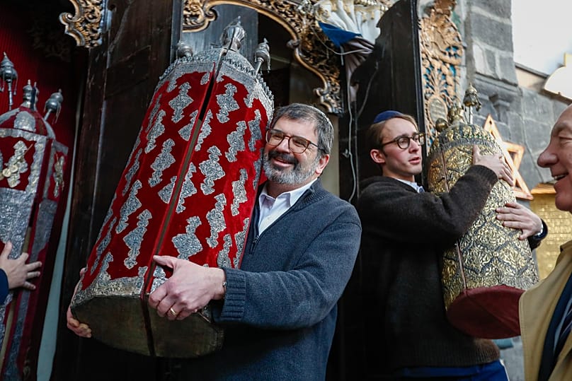 FILE: American-Jewish visitors hold Torah scrolls at a synagogue in the old city of Damascus, 18 February 2025