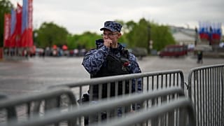 A Russian National Guard, known as a Rosguardia, stands at a police fence set up in Manezhnaya Square in Moscow, Russia, Friday, May 8, 2026,