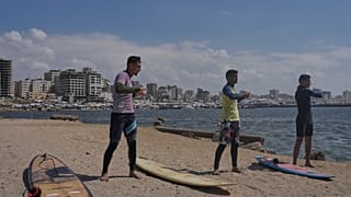 Surfers in war-torn Gaza find rare moments of joy taking to the waves