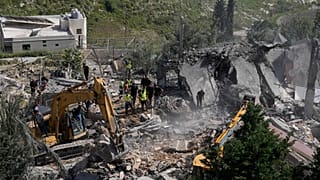 Rescue workers search for survivors using heavy machinery in the rubble of houses damaged by an Israeli airstrike in the village of Saksakieh, south Lebanon, Saturday, May 9, 
