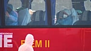 Passengers sit inside a bus after being disembarked from the hantavirus-stricken cruise ship MV Hondius at the port of Granadilla in Tenerife, Canary Islands, Spain, Sunday