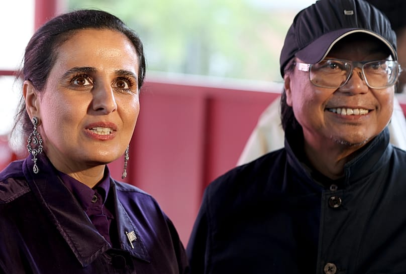 Qatar Museums Chairperson Sheikha Al Mayassa bint Hamad bin Khalifa Al Thani and artist Rirkrit Tiravanija inside Qatar National Pavilion at Venice Biennale.