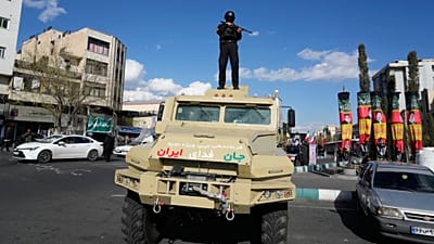 FILE: A member of police special forces stands guard on top their car at the Enqelab-e-Eslami, or Islamic Revolution, square in downtown Tehran, 30 March 2026