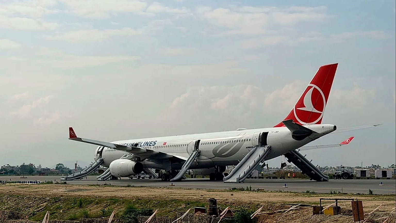 A Turkish Airlines aircraft is seen after passengers were safely evacuated and Nepal's main airport shut down in Kathmandu, 11 May, 2026
