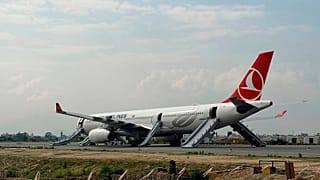 A Turkish Airlines aircraft is seen after passengers were safely evacuated and Nepal's main airport shut down in Kathmandu, 11 May, 2026