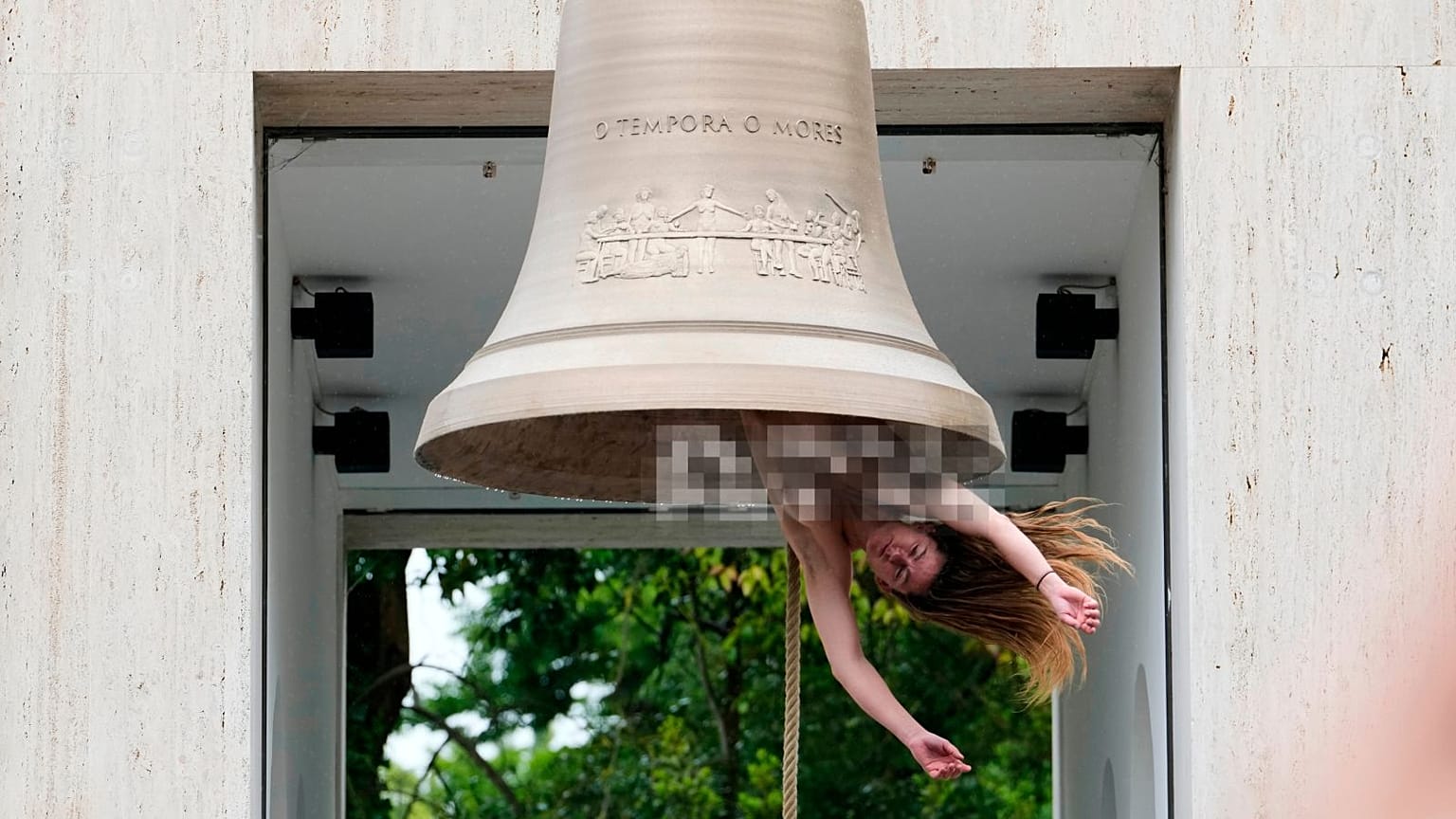A performer rings a bell with her body at the Austrian pavilion called 'Seaworld Venice' by artist Florentina Holzinger at the Venice 2026 Biennale Art