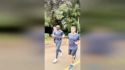 France's President Emmanuel Macron Macron and Kipchoge running alongside security detail in Kenya