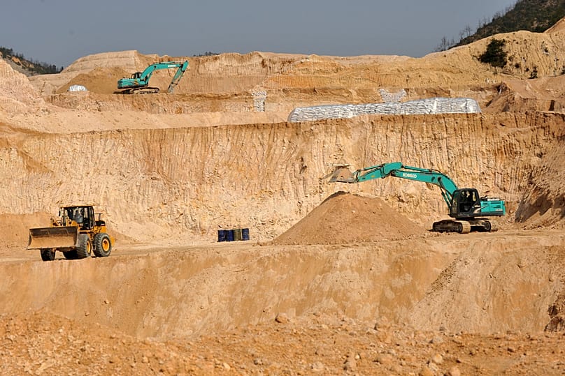 Workers use machinery to dig at a rare earth mine in Ganxian county in central China's Jiangxi province. (Chinatopix via AP, File)