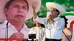 El candidato presidencial Roberto Sánchez, del partido Juntos por el Perú, pronuncia un discurso con una pancarta del expresidente Pedro Castillo de fondo, durante un mitin