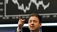 A trader gestures at the stock market in Frankfurt, Germany