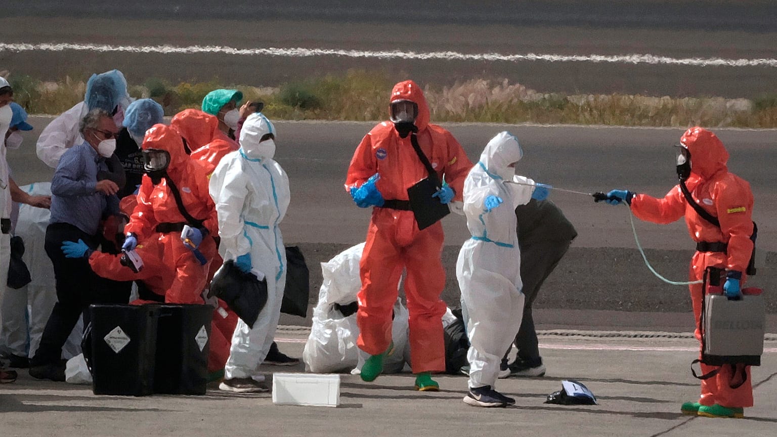 Passengers are sprayed with disinfectant after disembarking from the hantavirus-stricken cruise ship MV Hondius at Tenerife airport in the Canary Islands, Spain, May 10, 2026.