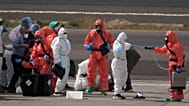 Passengers are sprayed with disinfectant after disembarking from the hantavirus-stricken cruise ship MV Hondius at Tenerife airport in the Canary Islands, Spain, May 10, 2026.