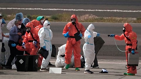 Passengers are sprayed with disinfectant after disembarking from the hantavirus-stricken cruise ship MV Hondius at Tenerife airport in the Canary Islands, Spain, May 10, 2026.