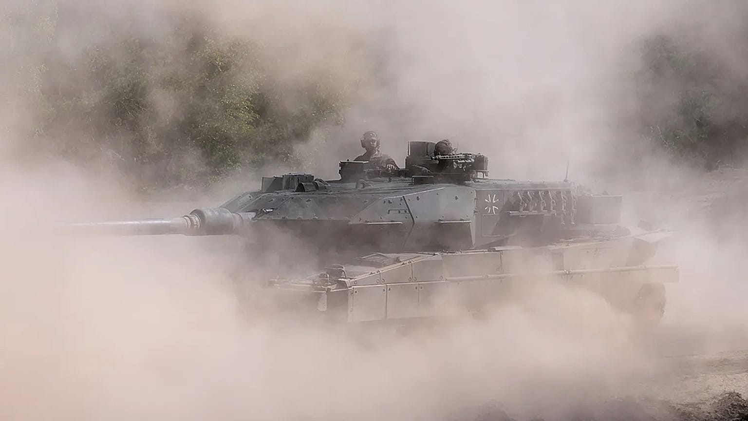 Soldiers drive a tank the dust at the Bundeswehr base in Munster, Germany, Thursday, April, 30, 2026. 